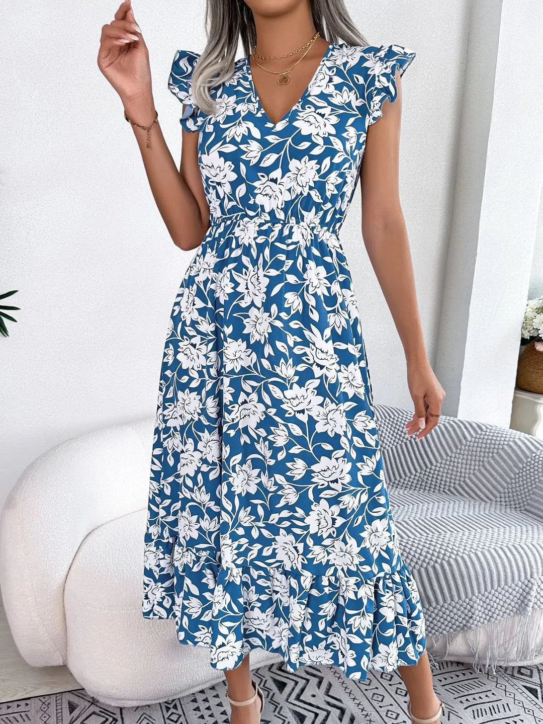 Women’s blue floral midi dress with white flower print, flutter sleeves, V-neckline, and ruffle hem – elegant summer outfit