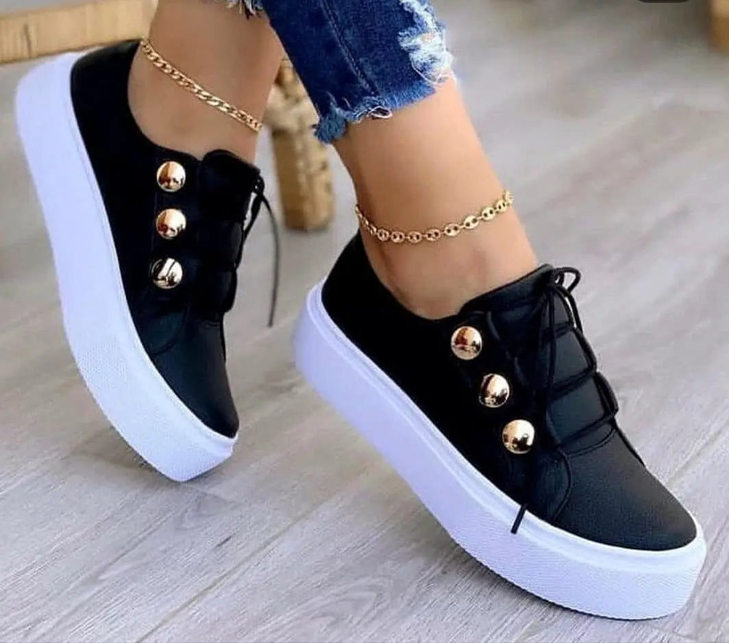 Black sneakers with gold buttons