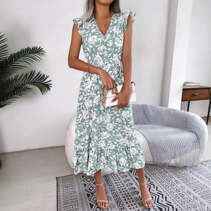 Women’s green floral midi dress with white flower print, flutter sleeves, V-neckline, and ruffle hem – elegant summer outfit