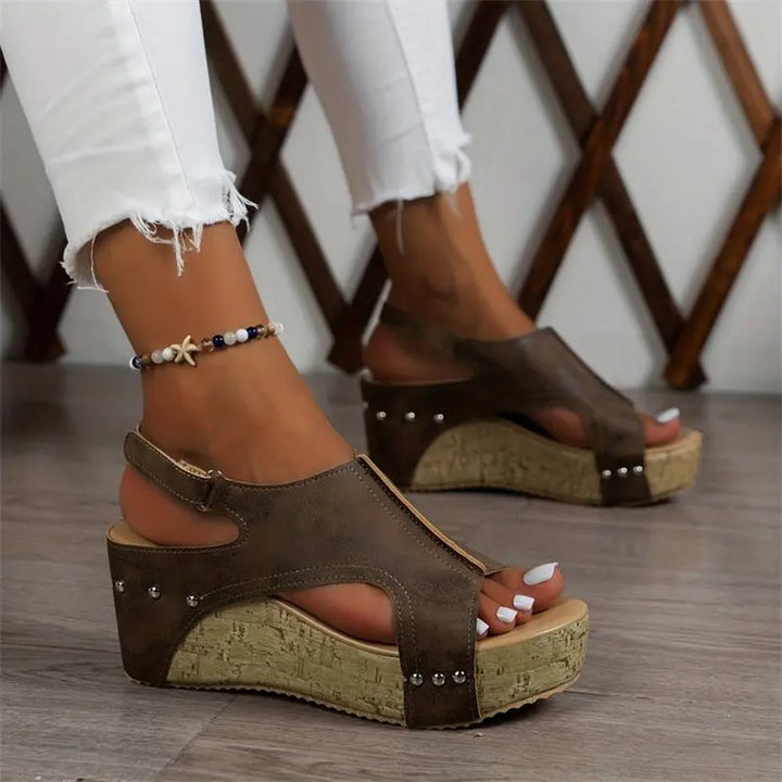 Women’s brown wedge sandals with cork platform sole, peep toe, ankle strap, and stud accents – casual summer footwear