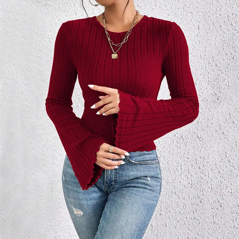 Chic red ribbed knit long sleeve sweater with bell sleeves and fitted waist, perfect for fall and winter outfits.