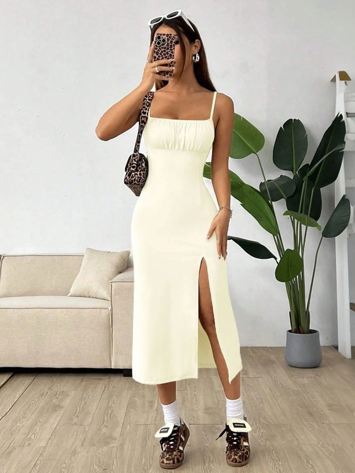 Women’s pastel yellow midi dress with spaghetti straps, ruched bust, and thigh-high side slit – elegant summer outfit