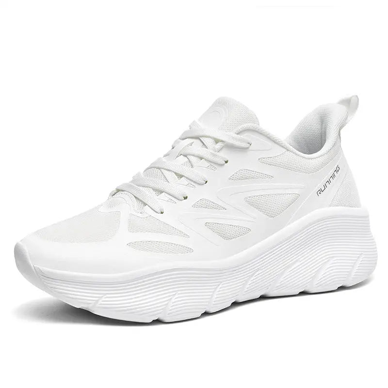A pair of white ActiveGlide Sports Shoes placed on a pedestal, showcasing the sole design